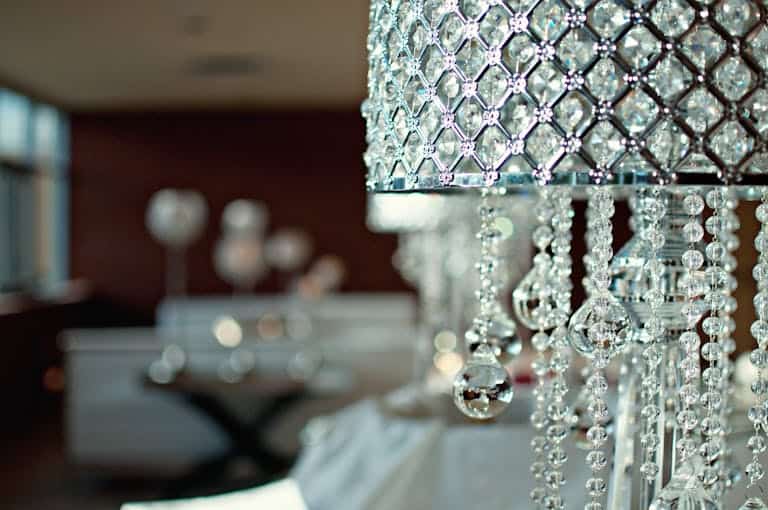 Elegant crystal lamp with intricate designs in a modern living room setting.