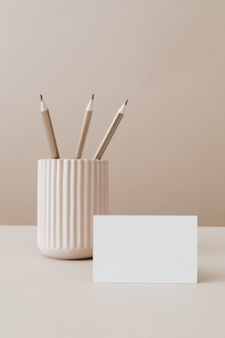 Pens and blank note card arranged neatly—perfect for writing heartfelt notes as words of affirmation gifts.