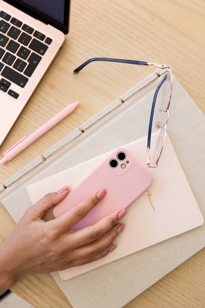 Midlife woman reaching for her phone in the morning to send Good Morning Texts for Family.